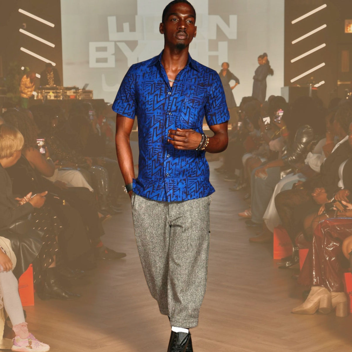 Each shirt is individually wax-printed, dyed, and stitched by Ghanaian artisans — no two ever the same.