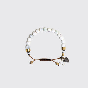 Three beaded bracelets on a wrist with charms reflecting the African continent attached