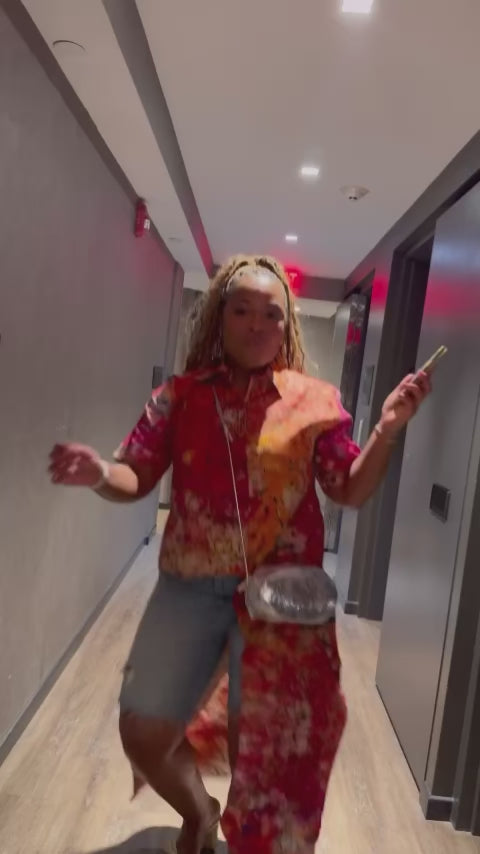 Where heritage meets head-turning design. This asymmetrical masterpiece brings artisanal Ghanaian craftsmanship to your everyday style. From the custom batik print to the fabric-covered buttons, every detail is thoughtfully handcrafted.